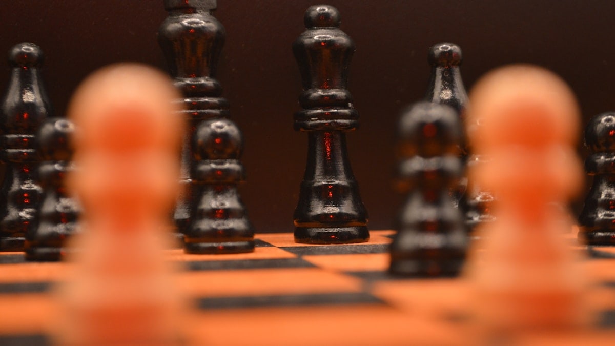 Black and white chess pieces on orange board